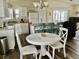 Charming dining area with white table and teal chairs at 322 Blackburn Blvd, North Port, FL 34287