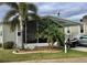 Mobile home with carport, golf cart, and landscaped yard at 322 Blackburn Blvd, North Port, FL 34287