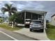 Mobile home with carport, golf cart, and landscaping at 322 Blackburn Blvd, North Port, FL 34287