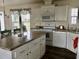 Modern kitchen with white cabinets, granite countertops and island at 322 Blackburn Blvd, North Port, FL 34287