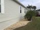 Side yard with landscaping and gravel at 322 Blackburn Blvd, North Port, FL 34287