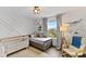 Bedroom featuring a crib, twin bed, and ocean-themed wall decor at 3409 Anchor Bay Trl, Lakewood Ranch, FL 34211