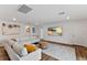 Bonus room with sectional sofa, shiplap wall, and large TV at 3409 Anchor Bay Trl, Lakewood Ranch, FL 34211