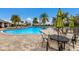 Resort-style pool with patio tables, chairs, and umbrellas at 3409 Anchor Bay Trl, Lakewood Ranch, FL 34211