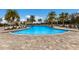 Resort-style pool with lounge chairs and patio seating at 3409 Anchor Bay Trl, Lakewood Ranch, FL 34211