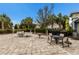 Outdoor fire pit and seating area with tables at 3409 Anchor Bay Trl, Lakewood Ranch, FL 34211