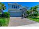 Two-story house with stone accents and a gray garage door at 3409 Anchor Bay Trl, Lakewood Ranch, FL 34211