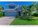 Two-story house with stone accents and a gray garage door at 3409 Anchor Bay Trl, Lakewood Ranch, FL 34211