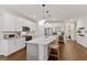 Modern kitchen with white cabinets, large island, and stainless steel appliances at 3409 Anchor Bay Trl, Lakewood Ranch, FL 34211