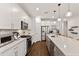 Gourmet kitchen with white cabinetry, large island, and high-end stainless steel appliances at 3409 Anchor Bay Trl, Lakewood Ranch, FL 34211