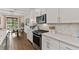 White kitchen with stainless steel appliances and subway tile backsplash at 3409 Anchor Bay Trl, Lakewood Ranch, FL 34211
