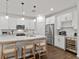 Modern kitchen with white cabinets, stainless steel appliances, and large island at 3409 Anchor Bay Trl, Lakewood Ranch, FL 34211