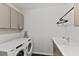 Laundry room with Whirlpool washer and dryer, cabinets, and a sink at 3409 Anchor Bay Trl, Lakewood Ranch, FL 34211