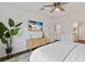 Main bedroom with a king-size bed, a TV, and access to a private bathroom at 3409 Anchor Bay Trl, Lakewood Ranch, FL 34211
