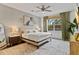 Relaxing main bedroom with a king-size bed, ceiling fan and large windows at 3409 Anchor Bay Trl, Lakewood Ranch, FL 34211