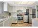 Condo kitchen with stainless steel appliances and light cabinets at 3622 Lake Bayshore Dr # K302, Bradenton, FL 34205
