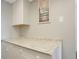 Kitchen counter with granite top and white cabinets at 3622 Lake Bayshore Dr # K302, Bradenton, FL 34205