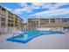 Community pool with surrounding patio furniture at 3622 Lake Bayshore Dr # K302, Bradenton, FL 34205