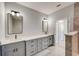 Modern bathroom with double vanity and a large mirror at 3850 Skyway Ave, North Port, FL 34288