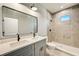 Modern bathroom with double vanity, large mirror and shower at 3850 Skyway Ave, North Port, FL 34288