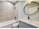 Clean bathroom with single vanity, tub, and tile shower at 3850 Skyway Ave, North Port, FL 34288