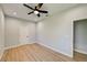 Well-lit bedroom featuring wood-look floors and ceiling fan at 3850 Skyway Ave, North Port, FL 34288