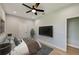 Spacious bedroom with large TV, ceiling fan and ample space at 3850 Skyway Ave, North Port, FL 34288