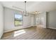 Bright dining room featuring a chandelier and large window at 3850 Skyway Ave, North Port, FL 34288