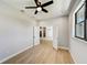 Light-filled home office with hardwood floors and ceiling fan at 3850 Skyway Ave, North Port, FL 34288