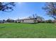 View of house exterior and large yard at 3850 Skyway Ave, North Port, FL 34288