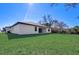House exterior with grassy backyard at 3850 Skyway Ave, North Port, FL 34288