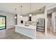 Modern kitchen featuring white cabinets, quartz countertops, and stainless steel appliances at 3850 Skyway Ave, North Port, FL 34288