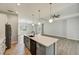 Open kitchen island with white cabinets and stainless steel appliances at 3850 Skyway Ave, North Port, FL 34288