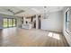 Open concept kitchen with island, white cabinets, and stainless steel appliances at 3850 Skyway Ave, North Port, FL 34288