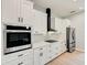 Modern kitchen with white cabinets, stainless steel appliances, and quartz countertops at 3850 Skyway Ave, North Port, FL 34288