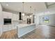 Open concept kitchen with island, white cabinets, and stainless steel appliances at 3850 Skyway Ave, North Port, FL 34288