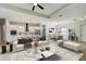Open living space with staged furniture and kitchen in view at 3850 Skyway Ave, North Port, FL 34288
