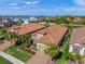 Aerial view of two-story home with tile roof, landscaping, and water views at 3904 Waypoint Ave, Osprey, FL 34229