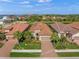 Aerial view of a single Gathering home with a two-car garage and lush landscaping at 3904 Waypoint Ave, Osprey, FL 34229