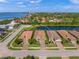 Aerial view showing three similar homes with tile roofs and landscaping at 3904 Waypoint Ave, Osprey, FL 34229