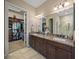 Elegant bathroom with double vanity, granite countertops, and large closet at 3904 Waypoint Ave, Osprey, FL 34229