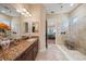 Spa-like bathroom with glass shower, double vanity, and granite countertop at 3904 Waypoint Ave, Osprey, FL 34229