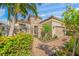 Front entry with stone accents, wrought-iron gate and lush landscaping at 3904 Waypoint Ave, Osprey, FL 34229