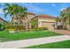 Tan house with tile roof, landscaping, and two-car garage at 3904 Waypoint Ave, Osprey, FL 34229