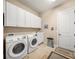Laundry room with washer, dryer, and cabinets at 3904 Waypoint Ave, Osprey, FL 34229