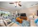 Bright living room featuring a comfy seating area and sliding doors to backyard at 3904 Waypoint Ave, Osprey, FL 34229