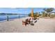 Relaxing waterfront patio with chairs and umbrellas at 3904 Waypoint Ave, Osprey, FL 34229