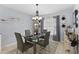 Dining room with glass table and modern chandelier at 4095 Redbird Cir, Sarasota, FL 34231