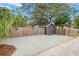 View of detached garage with gravel driveway and wood fence at 4536 1St N Ave, St Petersburg, FL 33713