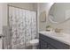 Bathroom with shower, sink, and patterned curtain at 4697 Antrim Dr, Sarasota, FL 34240